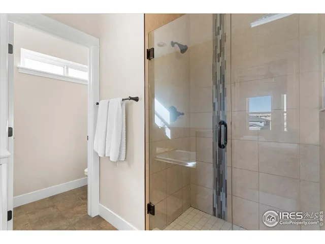 a bathroom with a shower and a sink