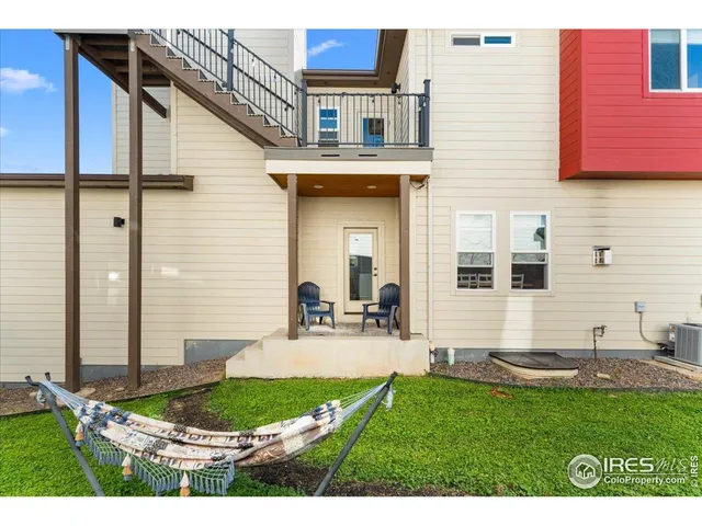 a view of a backyard with plants and patio