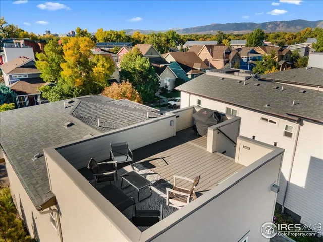 an aerial view of a house with a mountain