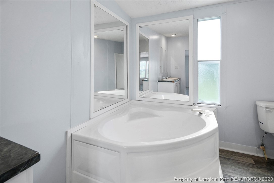 67 Apache Drive Parkton, NC 28371 - Photo 11 of 18 a bathroom with a tub and sink