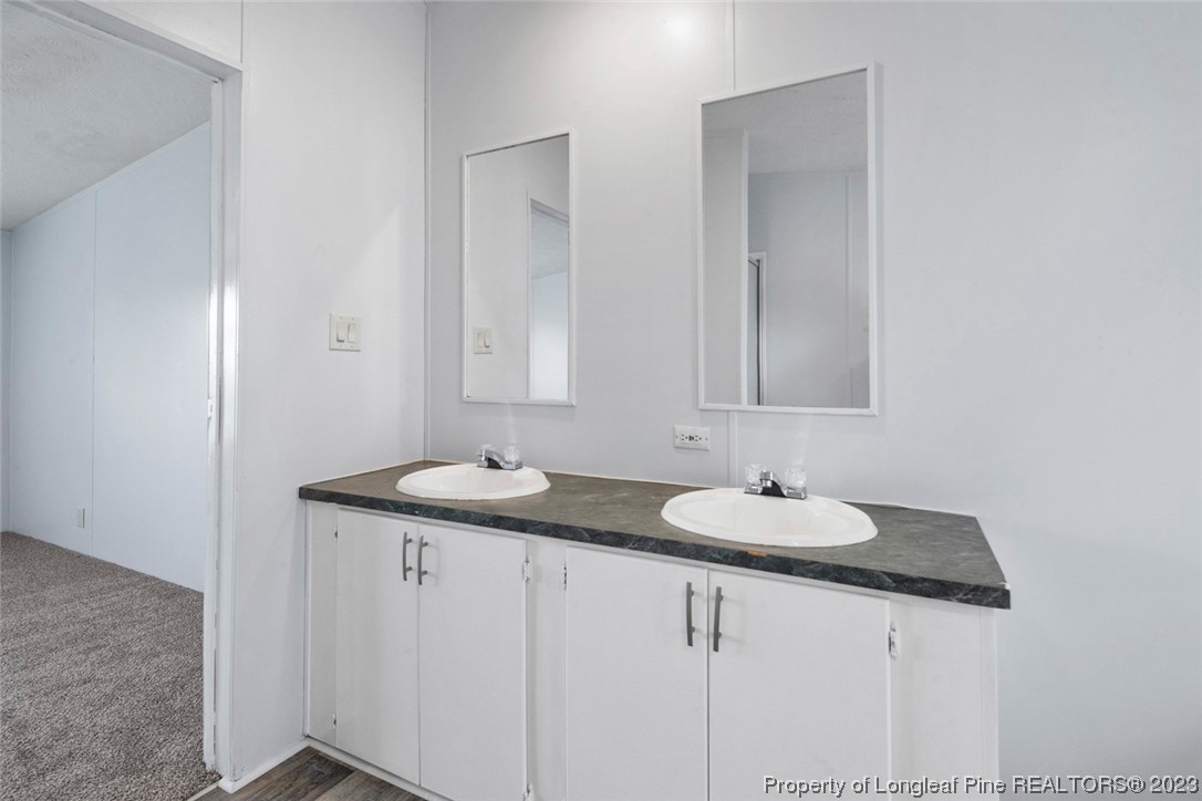 67 Apache Drive Parkton, NC 28371 - Photo 12 of 18 a bathroom with a sink and a mirror