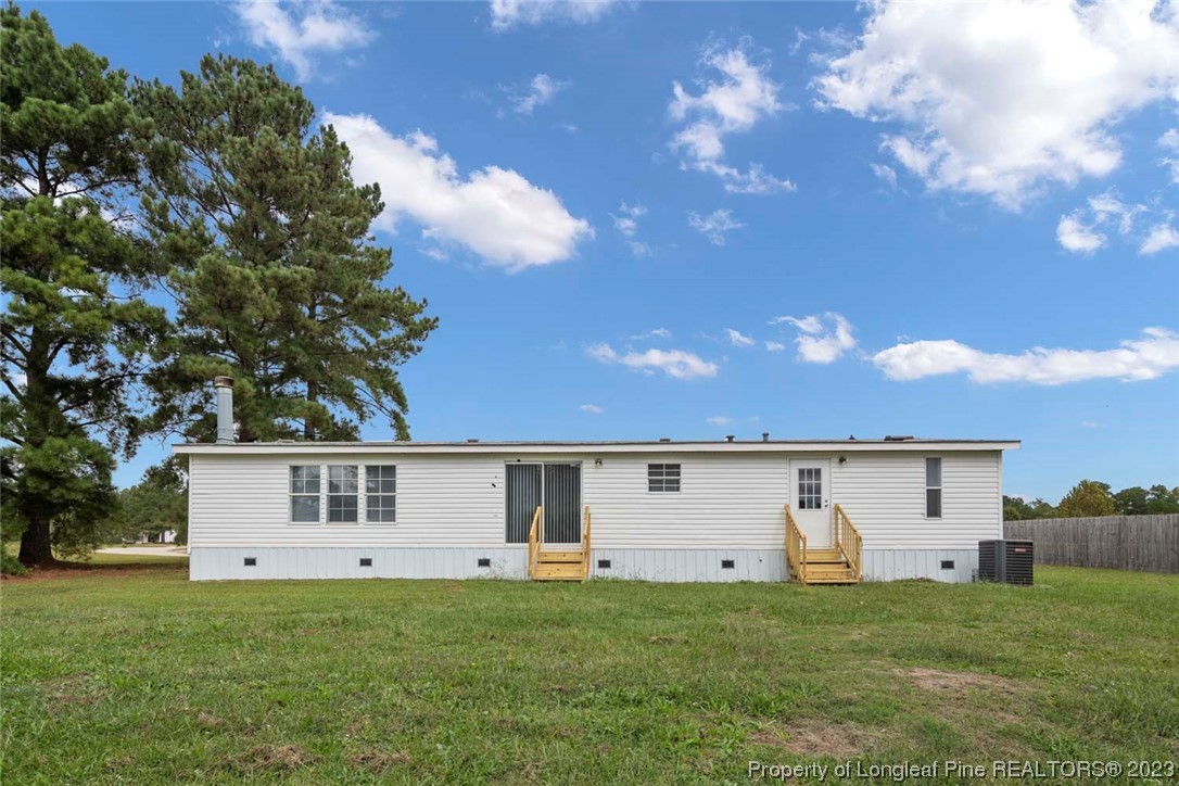 67 Apache Drive Parkton, NC 28371 - Photo 17 of 18 a front view of a house with a yard and garage