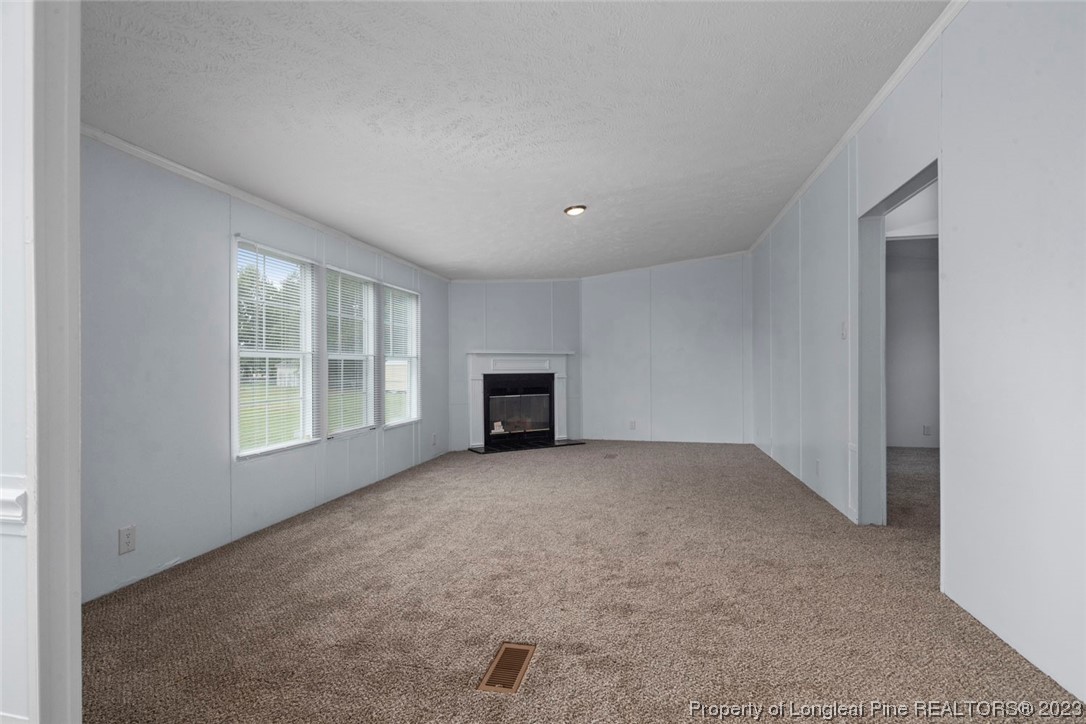 67 Apache Drive Parkton, NC 28371 - Photo 3 of 18 an empty room with windows