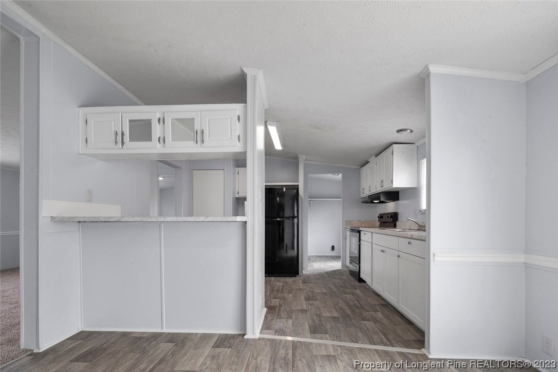67 Apache Drive Parkton, NC 28371 - Photo 5 of 18 a kitchen with cabinets and wooden floor