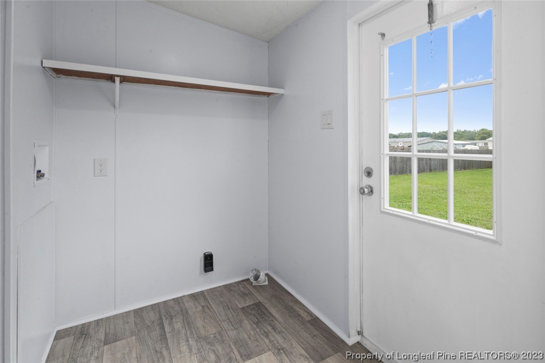 67 Apache Drive Parkton, NC 28371 - Photo 8 of 18 a view of an empty room with a window and wooden floor