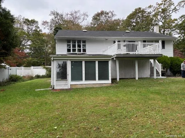 a view of a house with a yard and sitting area