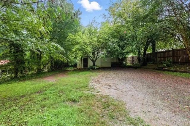 a view of a yard with an outdoor and trees
