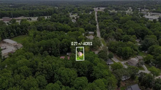an aerial view of a house with yard