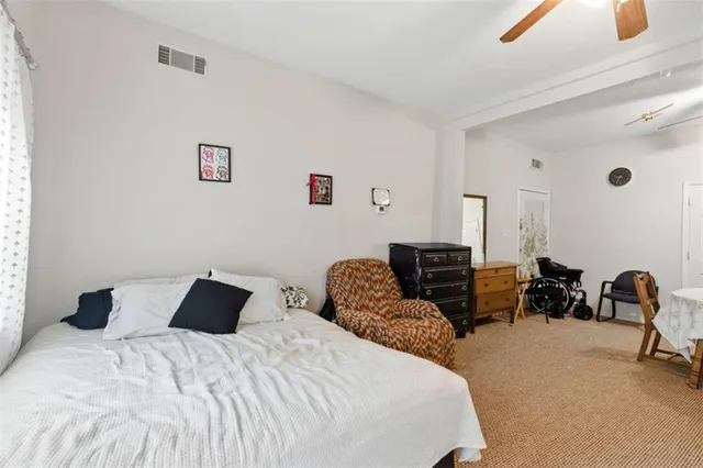 a bedroom with a bed and a chair