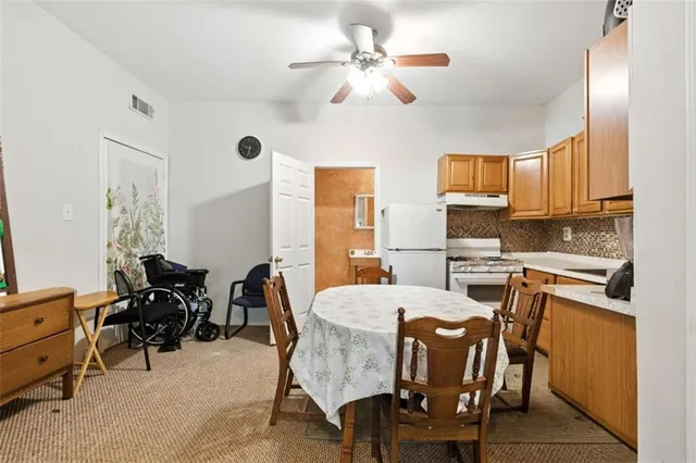 a view of a dining room with furniture and a chandelier