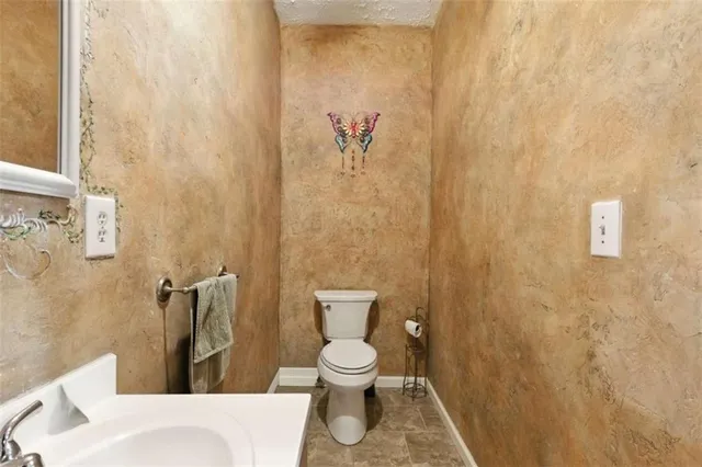 a bathroom with a toilet and a shower curtain