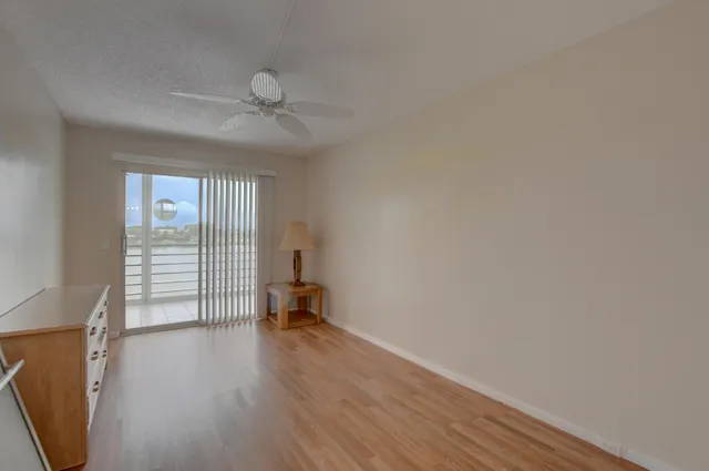 a view of a livingroom with wooden floor and a window