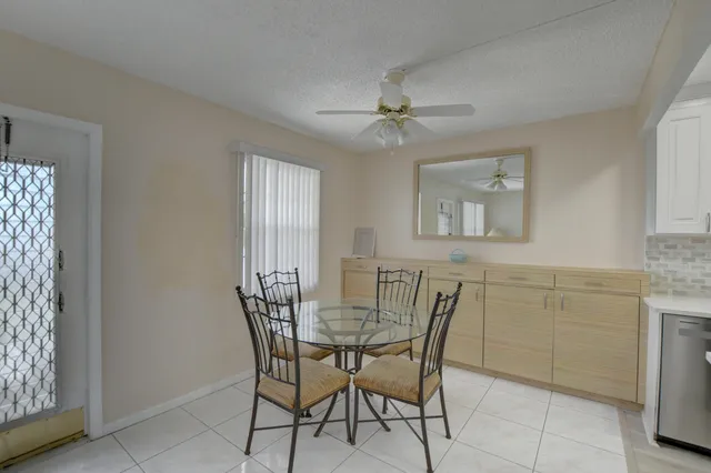 a view of a dining room with furniture and window
