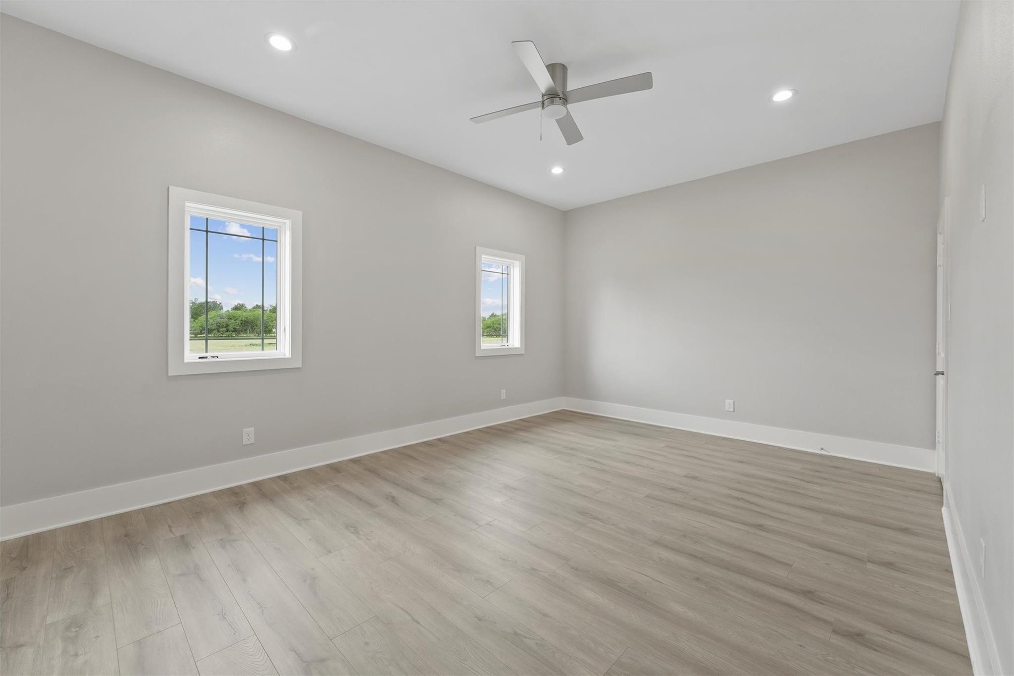 1900 Lezak Road Sealy, TX 77474 - Photo 13 of 34 a view of an empty room with a window and wooden floor