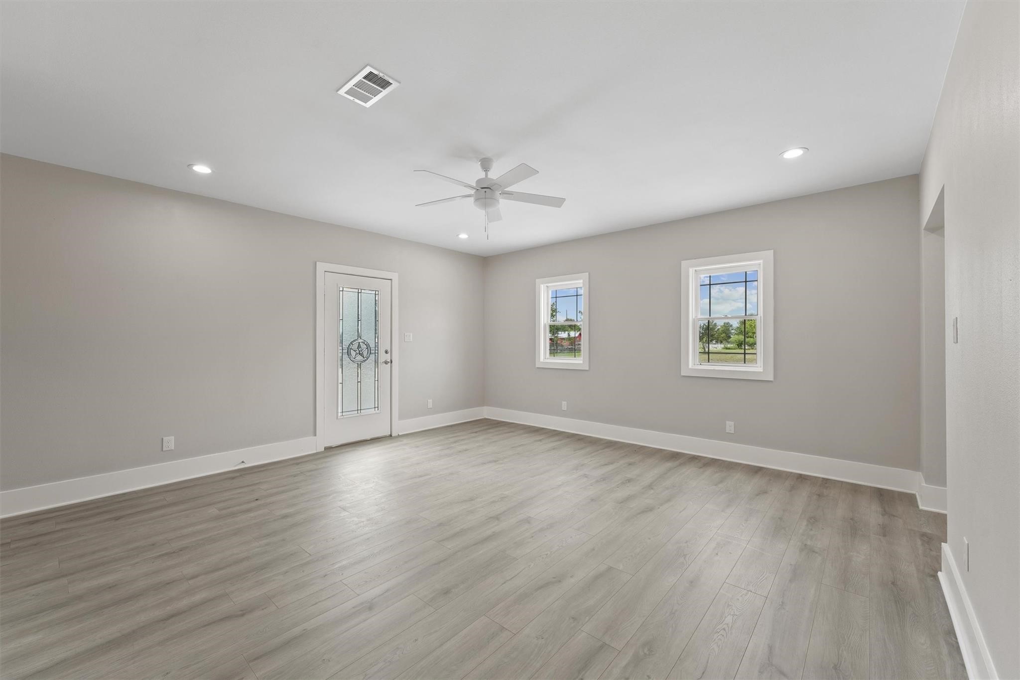 1900 Lezak Road Sealy, TX 77474 - Photo 14 of 34 an empty room with wooden floor and windows