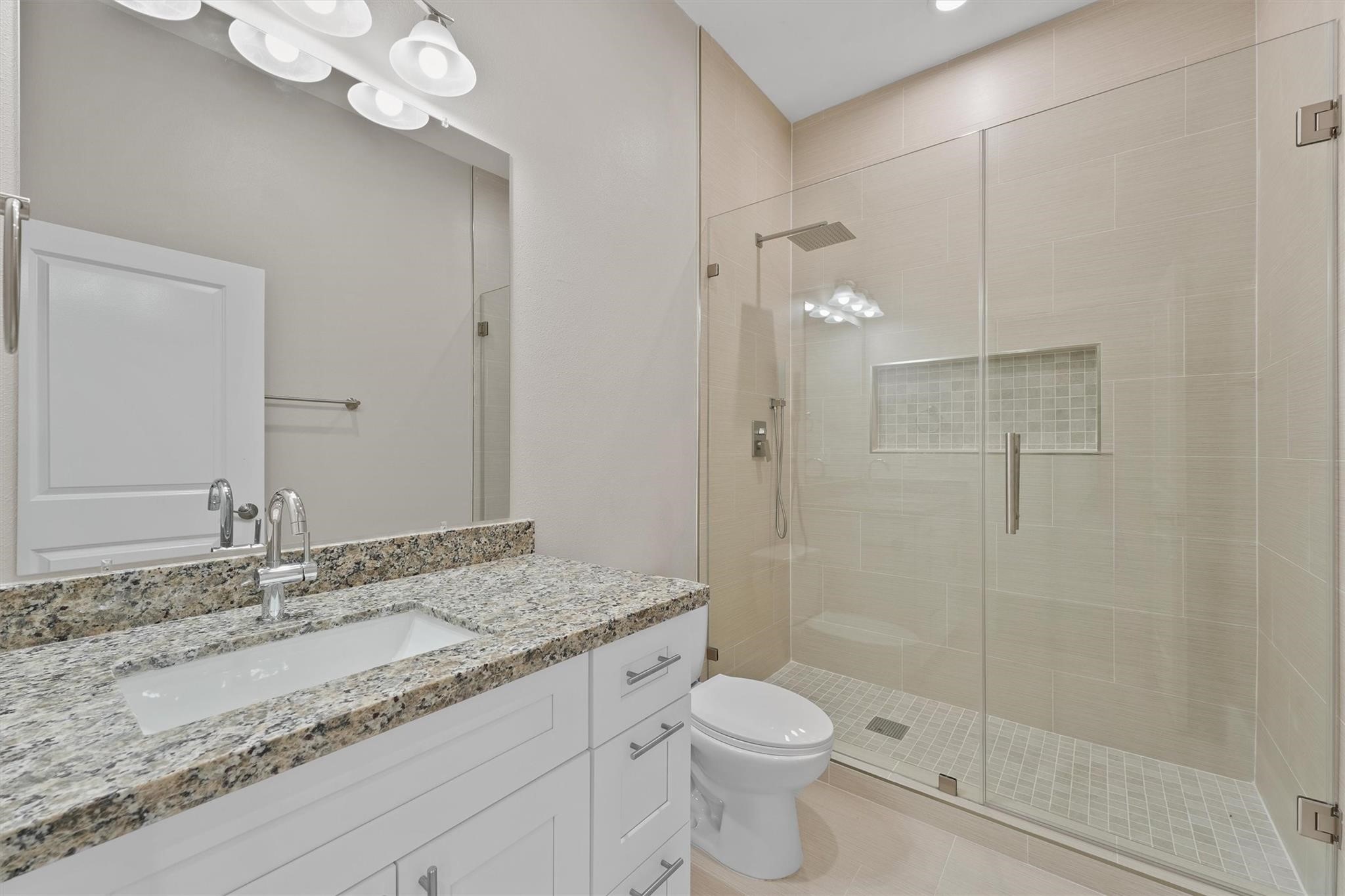 1900 Lezak Road Sealy, TX 77474 - Photo 17 of 34 a bathroom with a granite countertop sink a toilet and shower