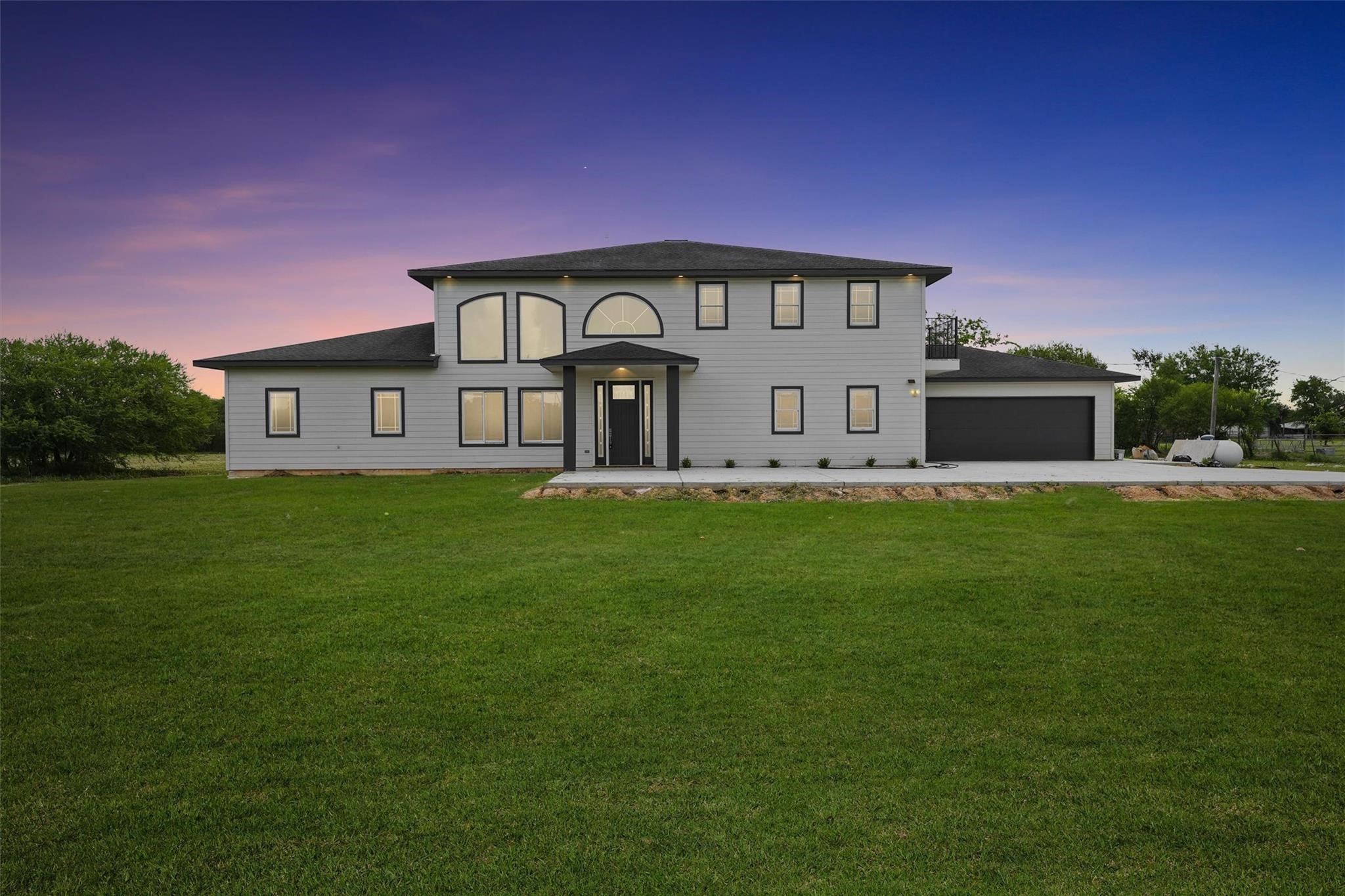 1900 Lezak Road Sealy, TX 77474 - Photo 2 of 34 a front view of a house with a garden