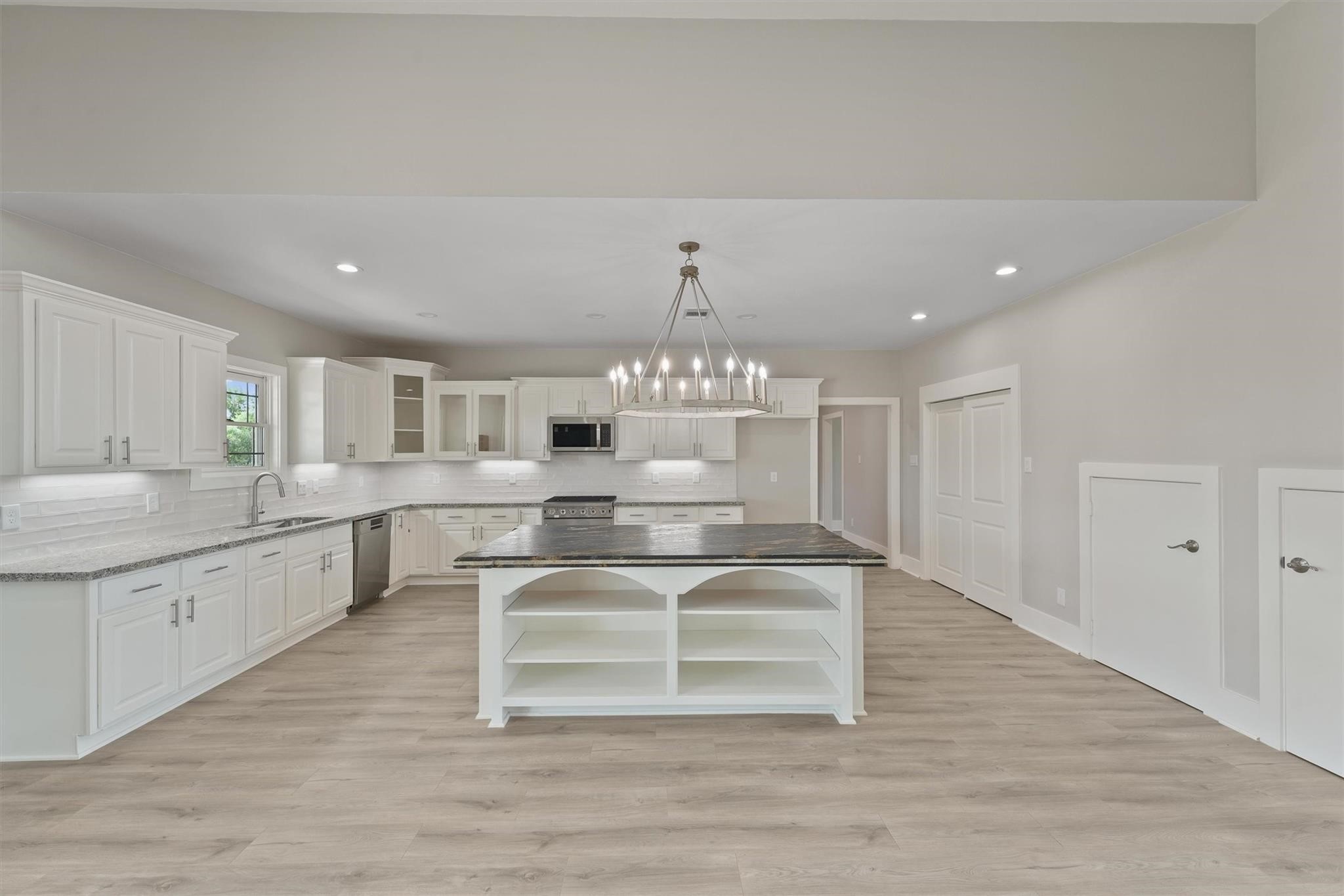 1900 Lezak Road Sealy, TX 77474 - Photo 8 of 34 a large white kitchen with kitchen island a sink stainless steel appliances and cabinets