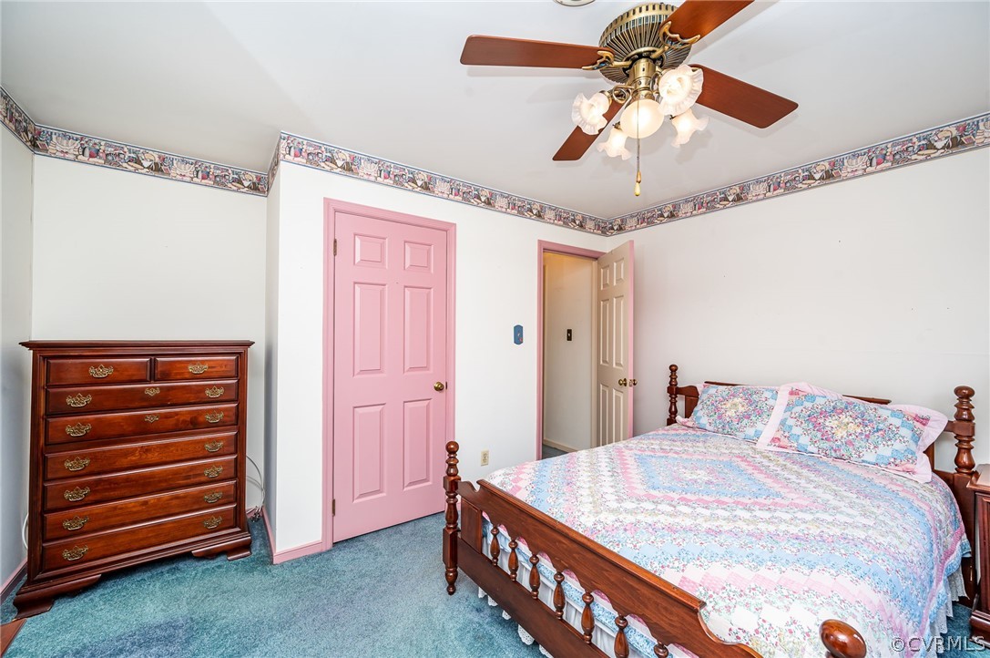 13001 Queensgate Road Midlothian, VA 23114 - Photo 18 of 21 a bedroom with a bed and a chandelier