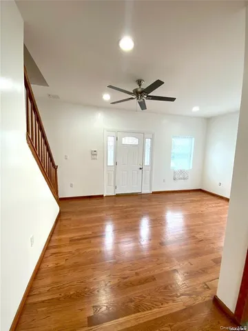 a view of a room with wooden floor and white walls