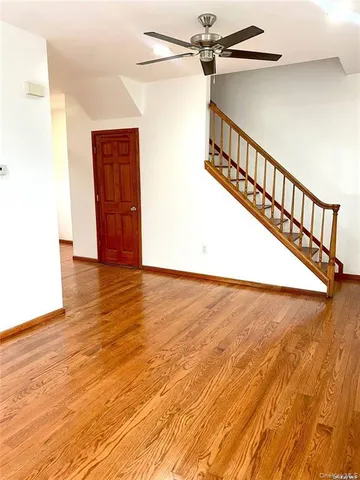 a view of an entryway with wooden floor