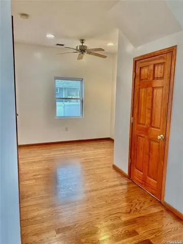 an empty room with wooden floor and closet