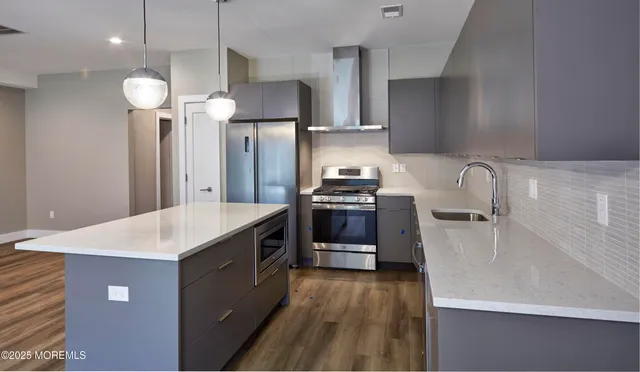 a kitchen with a sink a stove and refrigerator