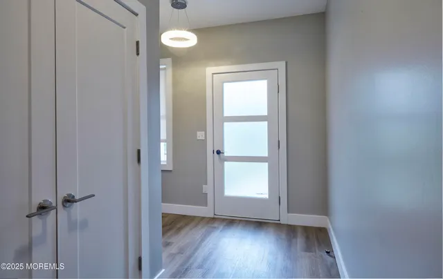 an empty room with wooden floor and a window