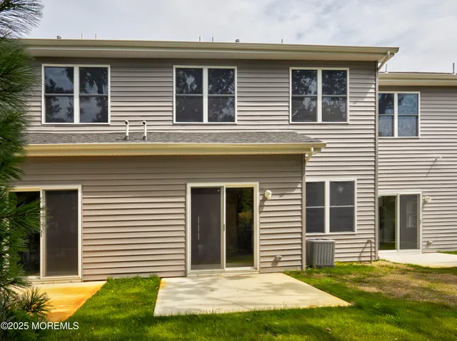 a view of a house with a yard and a large window