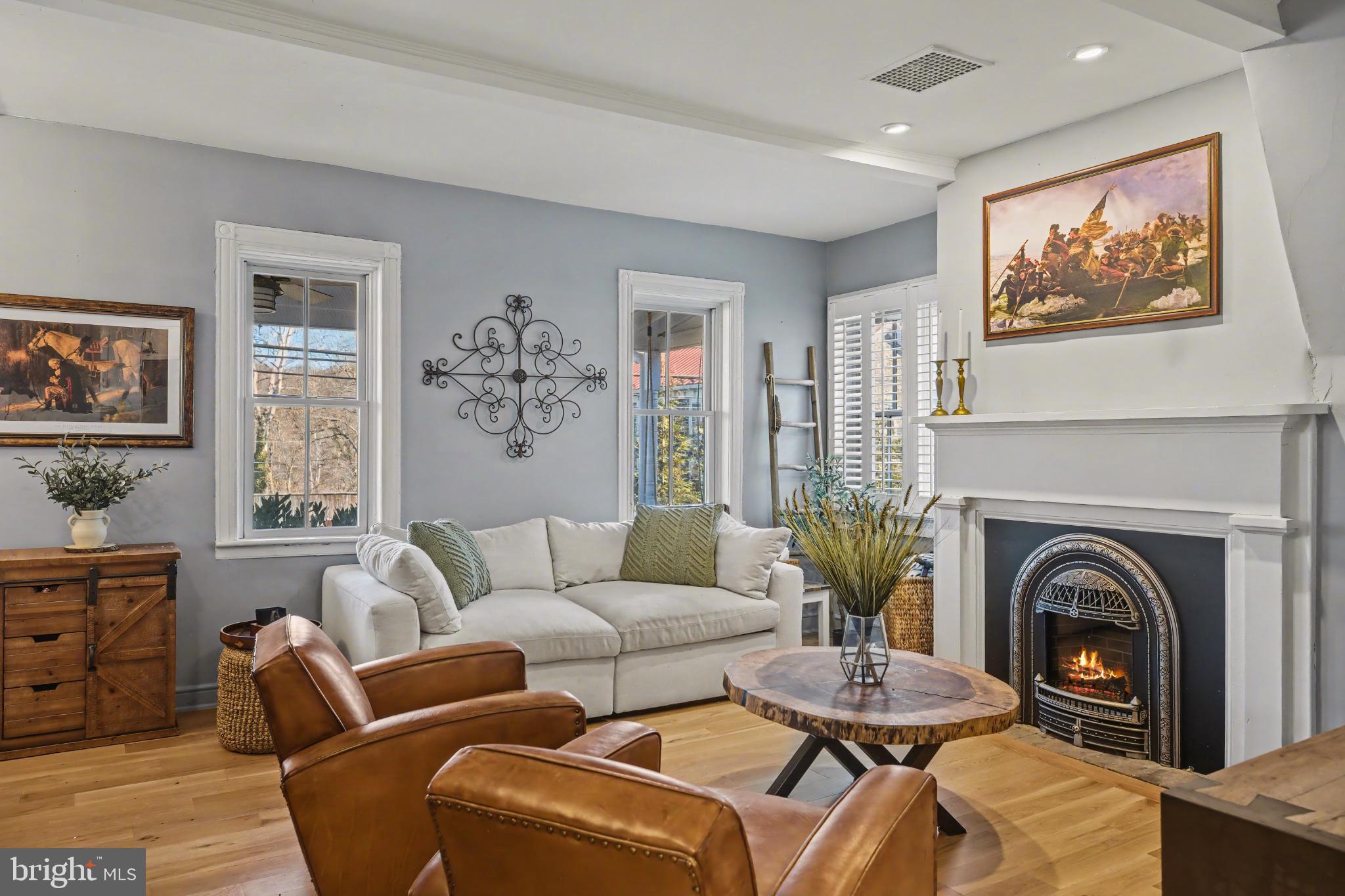 4934 River Road New Hope, PA 18938 - Photo 4 of 56 a living room with furniture a fireplace and a large window