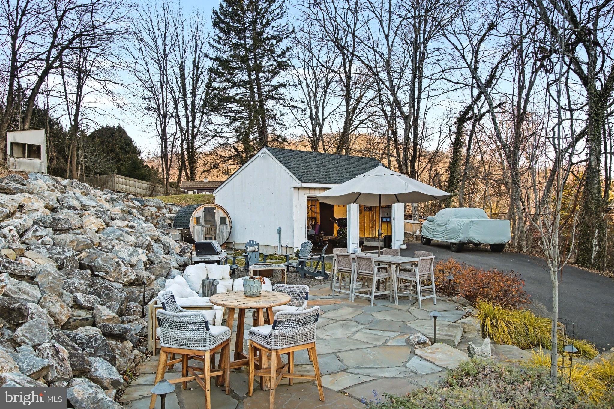 4934 River Road New Hope, PA 18938 - Photo 45 of 56 a view of a patio with a table and chairs under an umbrella