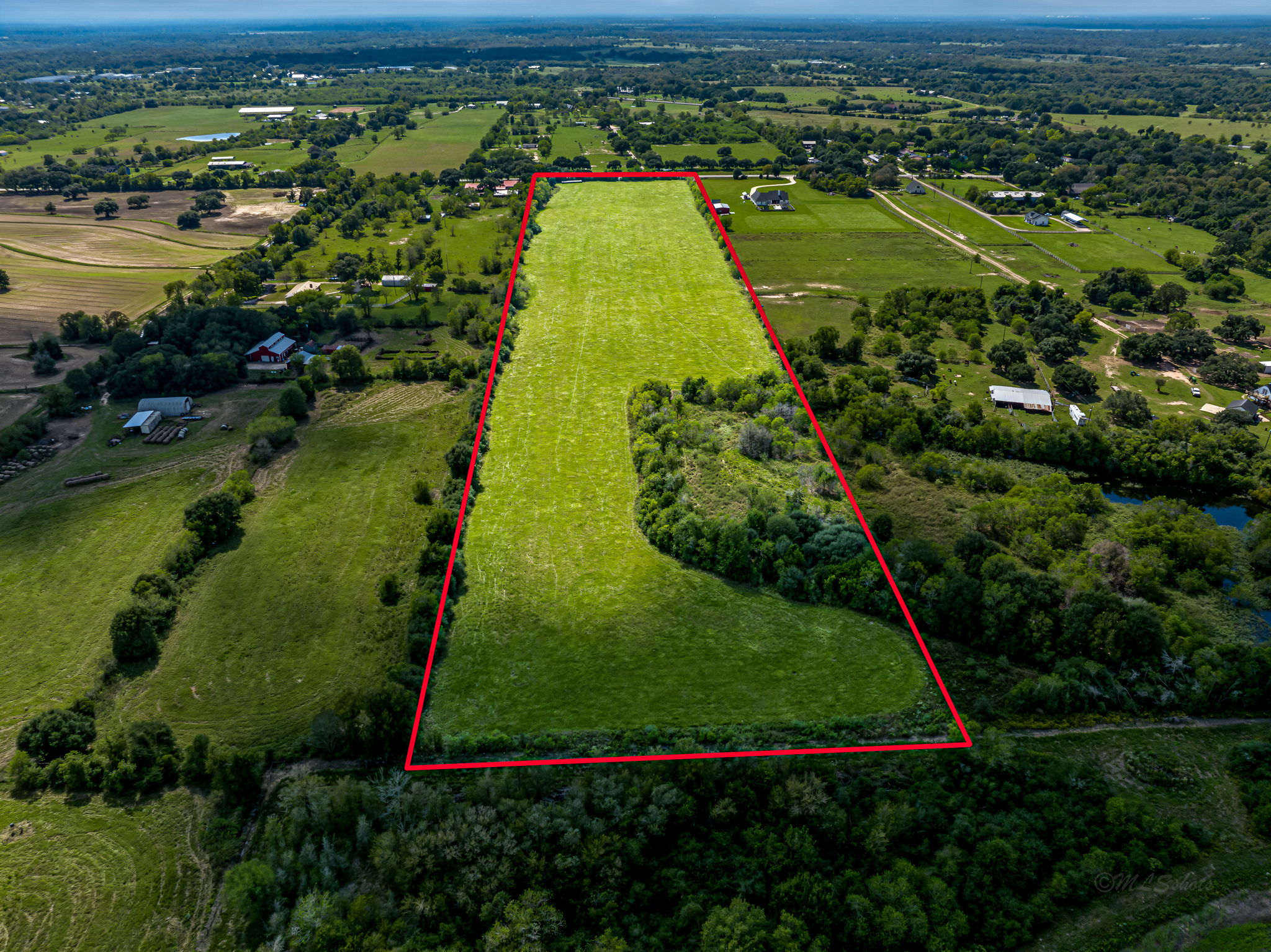 37280 Clapp Road Brookshire, TX 77423 - Photo 13 of 34 Vast green pastures and mature trees characterize this expansive rural acreage.