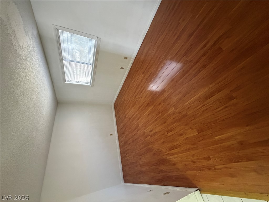 2236 East Desert Inn Road Las Vegas, NV 89169 - Photo 23 of 34 Natural light floods this inviting room, showcasing gleaming hardwood flooring.