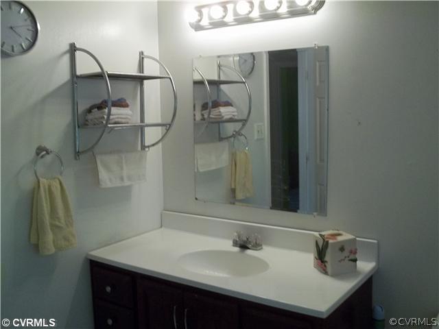 4706 Brookridge Road Chesterfield, VA 23832 - Photo 7 of 9 a bathroom with a sink and mirror