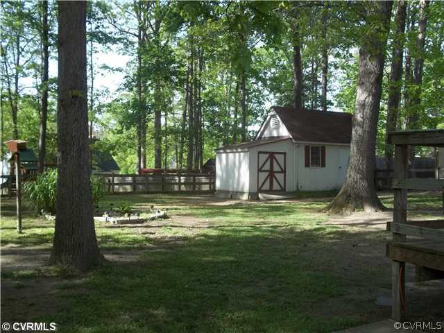 4706 Brookridge Road Chesterfield, VA 23832 - Photo 9 of 9 a backyard of a house with yard table and chairs