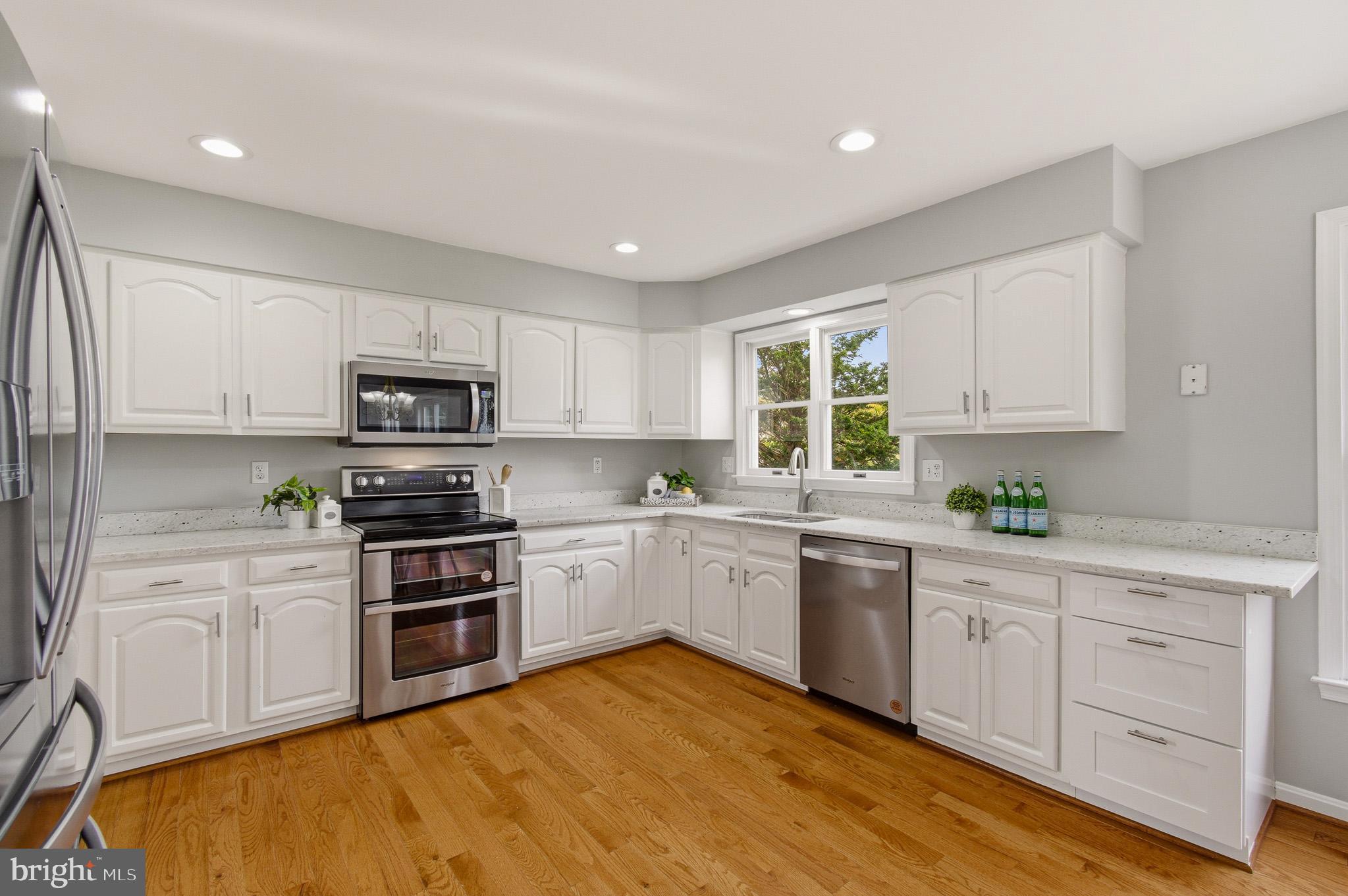 4518 Haywagon Way Ellicott City, MD 21043 - Photo 15 of 54 a kitchen with white cabinets appliances and a window