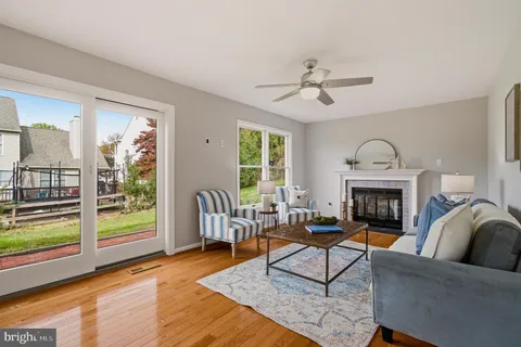 a living room with furniture a fireplace and a table
