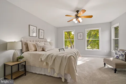 a spacious bedroom with a bed and a window