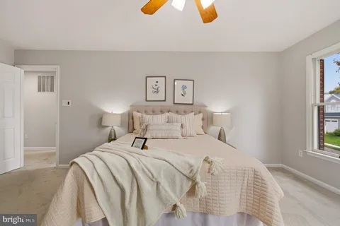 a bedroom with a bed and painting on the wall