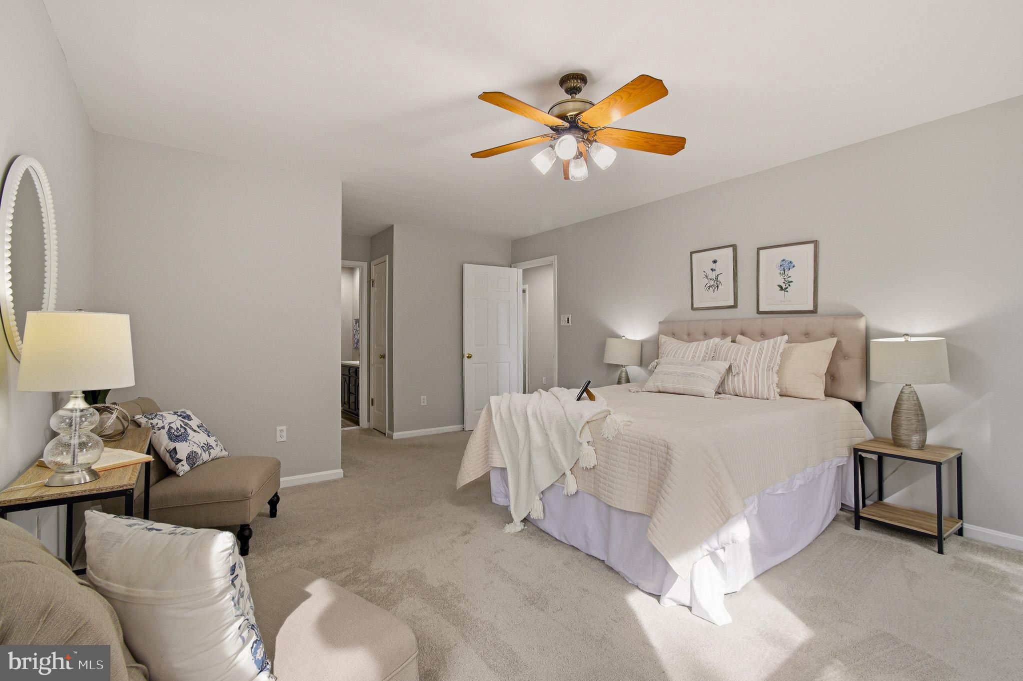 4518 Haywagon Way Ellicott City, MD 21043 - Photo 28 of 54 a spacious bedroom with a bed and a chandelier