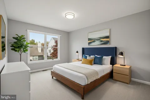 a bedroom with a bed and a potted plant