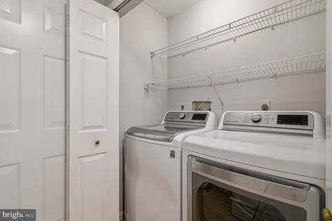 a living room with furniture a lamp and a flat screen tv