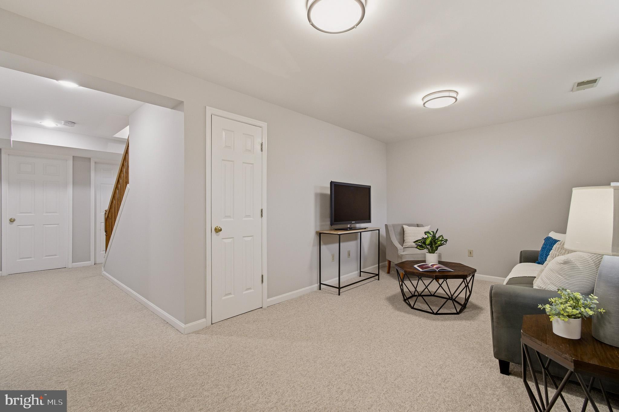 4518 Haywagon Way Ellicott City, MD 21043 - Photo 40 of 54 a living room with furniture and a flat screen tv