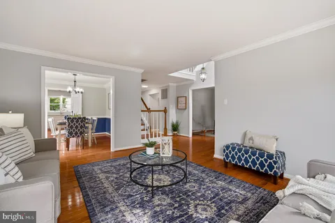 a living room with furniture rug and a table