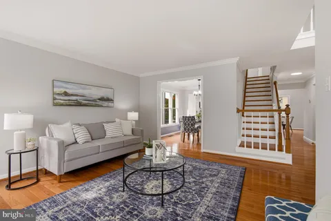 a living room with furniture a rug and a table