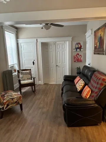 a living room with furniture and a wooden floor