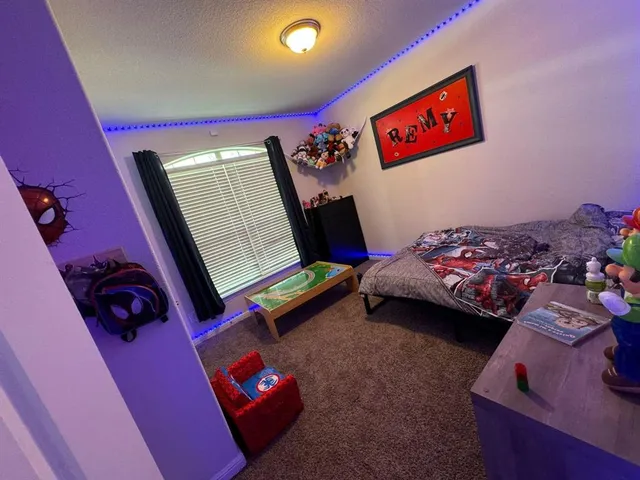 a bedroom with bed and a window