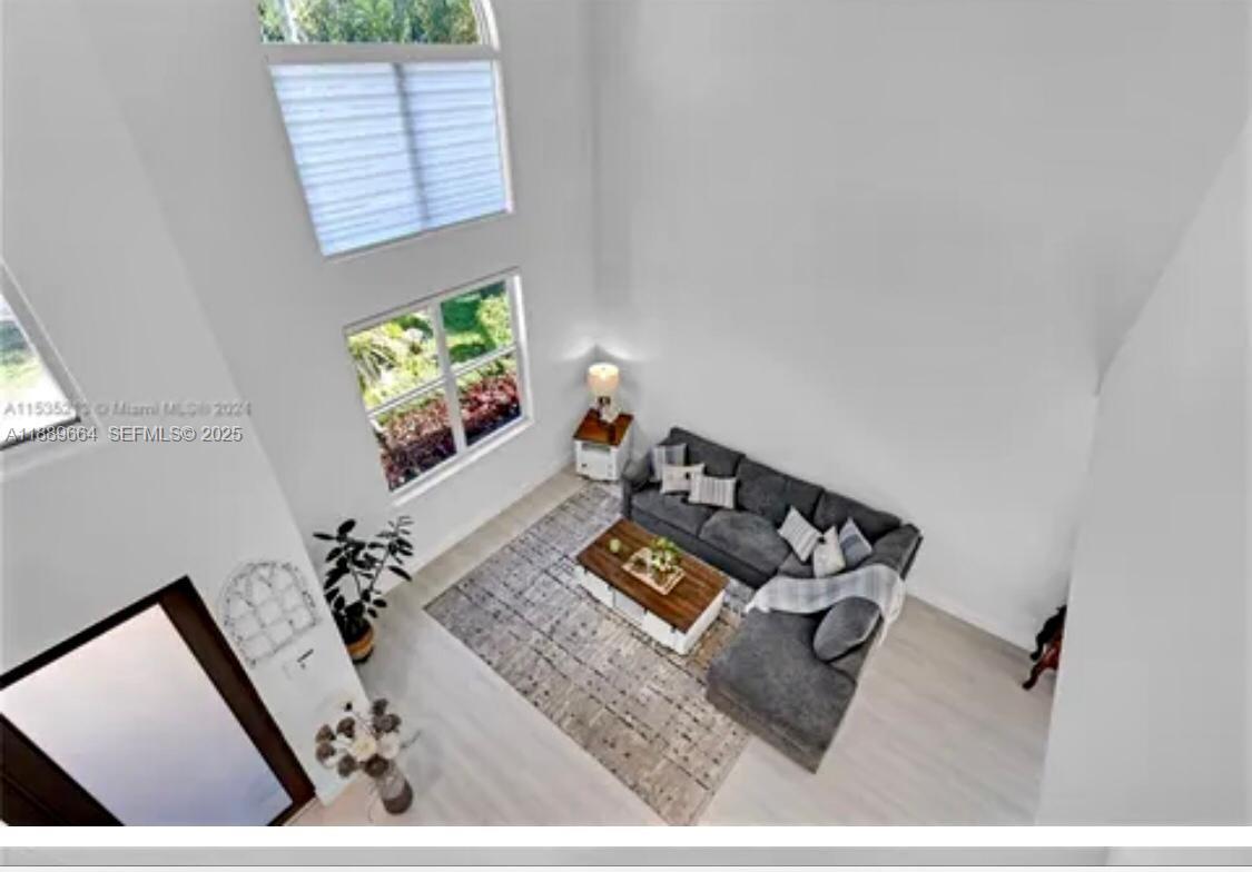 12071 Southwest 1st Street Miami, FL 33184 - Photo 12 of 13 a living room with furniture and a flat screen tv