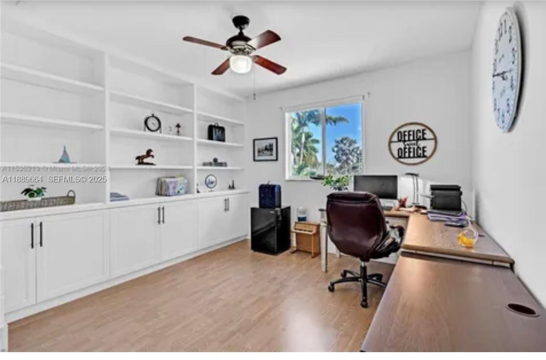 12071 Southwest 1st Street Miami, FL 33184 - Photo 13 of 13 a workspace with a desk chair and painted walls