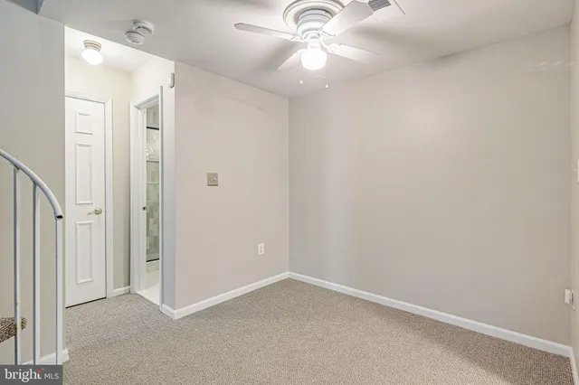 a kitchen with stainless steel appliances a refrigerator and a chandelier